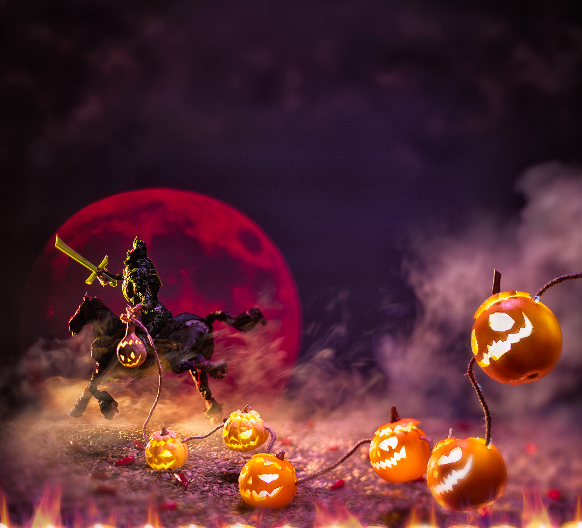 A headless rider made out of kale holding a sword in one hand several pumpkins with carved out faces on a rope in the other hand, is sitting on a horse which is also made out of kale, a red full moon behind them, and riding into the fog.