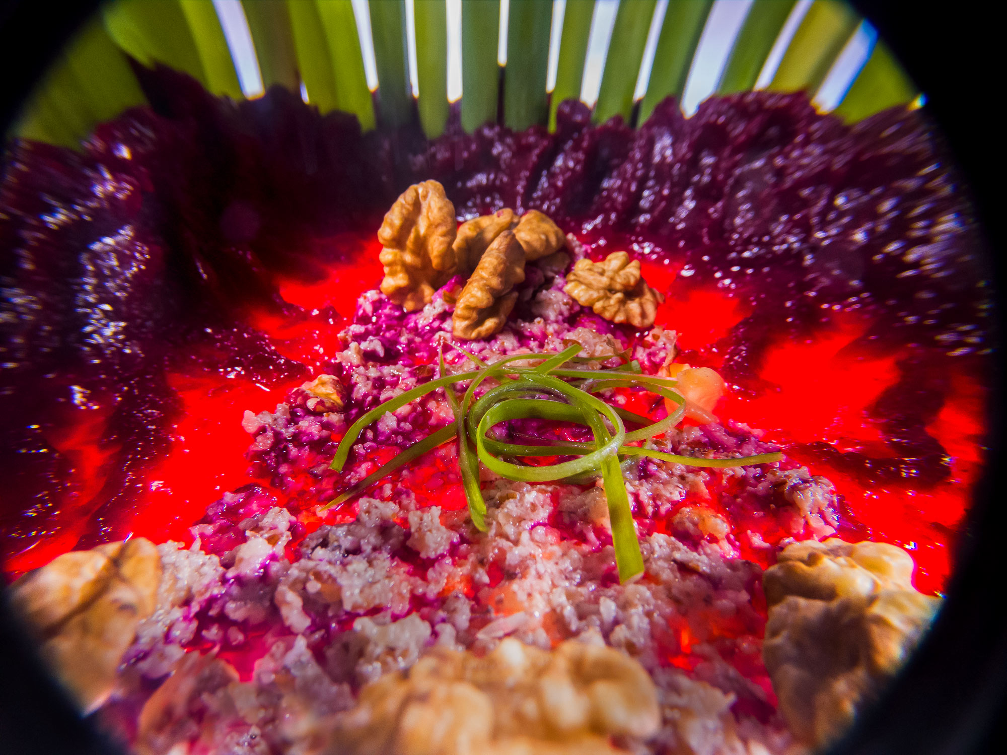 Inside food photo series, depicting a close up view of a beetroot salad with walnuts.